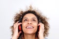 Close up beautiful young african american woman listening to music on headphones and looking up Royalty Free Stock Photo