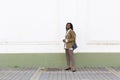 Close up portrait of a beautiful young african american woman with pigtails hairstyle in a business suit and white blouse walks Royalty Free Stock Photo