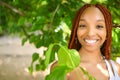 Close up portrait Beautiful young African American woman with red braids hair, perfect white teeth smiling outside Royalty Free Stock Photo