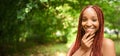 Close up portrait Beautiful young African American woman with red braids hair, perfect white teeth smiling outside Royalty Free Stock Photo