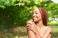 Close up portrait Beautiful young African American woman with red braids hair, perfect white teeth smiling outside Royalty Free Stock Photo