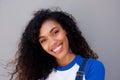 Close up beautiful young african american woman smiling against gray backgorund Royalty Free Stock Photo