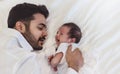 Close up portrait of beautiful young asian or caucasian father looking at healthy crying newborn baby. Royalty Free Stock Photo