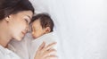 Close up portrait of beautiful young asian or caucasian mother with her healthy newborn baby. Royalty Free Stock Photo