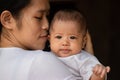 Close-up portrait of beautiful young Asian mother holding baby girl Royalty Free Stock Photo