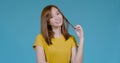 Close up Portrait of beautiful young asian woman smiling holding hair in yellow T-shirt Royalty Free Stock Photo