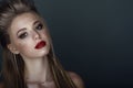 Close up portrait of beautiful young blond model with perfect provocative make up and stylish hairstyle Royalty Free Stock Photo