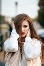 Close-up portrait of a beautiful young confident girl or businesswoman in a white suit with a beautiful make-up and hairdo on Royalty Free Stock Photo