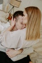 Close-up portrait of a beautiful young couple hugs in bed at home Royalty Free Stock Photo