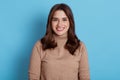 Close up portrait of beautiful young European woman model with dark hair looking at camera with charming cute smile while posing Royalty Free Stock Photo