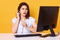 Close up portrait of beautiful young girl with head phones, poses at yellow background, with astonished facial expression, hears Royalty Free Stock Photo