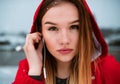 A close-up portrait of young girl or woman with earphones outdoors, listening to music. Royalty Free Stock Photo