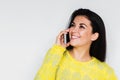 Close up portrait of beautiful young happy woman with smart phone, wearing yellow sweater, with pretty toothy smile Royalty Free Stock Photo