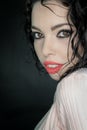 Close up portrait of a beautiful young woman with curly black hair and red lipstick Royalty Free Stock Photo