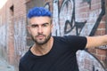 Close-up portrait of a beautiful young man with blue hair. Men's beauty, fashion. Royalty Free Stock Photo