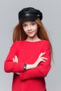 Close-up portrait of beautiful young redhead girl wearing red sweater posing in studio. Royalty Free Stock Photo