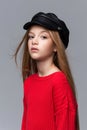 Close-up portrait of beautiful young redhead girl wearing red sweater posing in studio. Royalty Free Stock Photo