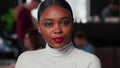 Close-up portrait of beautiful young 20s black business woman with red lips looking at camera at light trendy office. Royalty Free Stock Photo