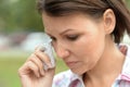 Close up portrait of beautiful young sad woman in park Royalty Free Stock Photo