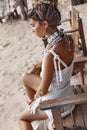 Close up portrait of beautiful young stylish boho woman on the beach at sunset Royalty Free Stock Photo