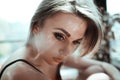 Close up portrait of a beautiful young woman with blond hair. Flare light photo effect. Girl with nude make up, fashion Royalty Free Stock Photo