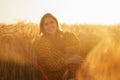 Close-up portrait of beautiful young woman in a countryside field. Female face in the rays of sunset. Freedome and