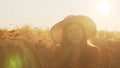 Close-up portrait of beautiful young woman in a field. Female face in the rays of sunset. Freedome and happiness concept