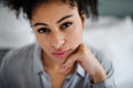 Close-up portrait of beautiful young woman indoors, looking at camera. Royalty Free Stock Photo