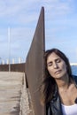 Close up portrait of beautiful young woman leaning on a wall outdoors while eyes closed thinking Royalty Free Stock Photo