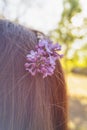 Close-up. Portrait of a beautiful young woman. Lilac in the hair of a girl