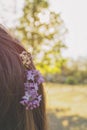 Close-up. Portrait of a beautiful young woman. Lilac in the hair of a girl