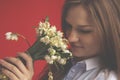 Close up portrait of beautiful young woman with lilies of the valley as symbol of happiness, love and youth. Horizontal image