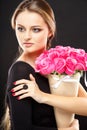 Close-up portrait of beautiful young woman with luxury jewelry and perfect make up holding bouquet Royalty Free Stock Photo