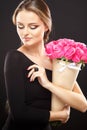 Close-up portrait of beautiful young woman with luxury jewelry and perfect make up holding bouquet Royalty Free Stock Photo