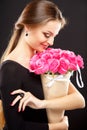 Close-up portrait of beautiful young woman with luxury jewelry and perfect make up holding bouquet Royalty Free Stock Photo