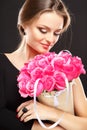 Close-up portrait of beautiful young woman with luxury jewelry and perfect make up holding bouquet Royalty Free Stock Photo