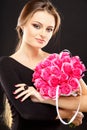 Close-up portrait of beautiful young woman with luxury jewelry and perfect make up holding bouquet Royalty Free Stock Photo