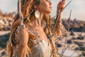 Close up portrait of beautiful young woman model with boho accessories outdoors at sunset Royalty Free Stock Photo