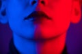 Close-up portrait of beautiful young woman with short hair in neon light. Girl with sensual lips in ultraviolet light. Royalty Free Stock Photo