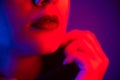 Close-up portrait of beautiful young woman with short hair in neon light. Girl with sensual lips in ultraviolet light. Royalty Free Stock Photo