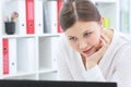 Close up portrait of a beautiful young woman smiling and looking at laptop screen. Royalty Free Stock Photo