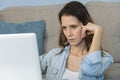 Close up portrait of a beautiful young woman smiling and looking at laptop screen Royalty Free Stock Photo