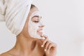 Close-up portrait beautiful young woman smiling with towels after take bath make cosmetic mask on her face. Rejuvenation