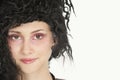 Close-up portrait of beautiful young woman with teased hair over gray background Royalty Free Stock Photo