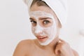 Close-up portrait of beautiful young woman with towels after take bath make cosmetic mask on her face. Rejuvenation