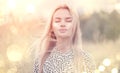 Close Up Portrait of beauty girl with fluttering white hair enjoying nature outdoors, on a field. Flying blonde hair on the wind Royalty Free Stock Photo