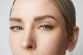 Close-up portrait Beauty women with big blue eyes and dark eyebrows looking at camera.Model with light nude make-up Royalty Free Stock Photo