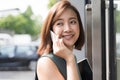 Close up Portrait of beauty young Asian business woman talking on the phone outside of office. Royalty Free Stock Photo