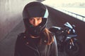 Close-up portrait of a biker girl inside the bridge.