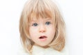 Close up portrait blond hair baby girl with a scratch on her nose isolated on the white background. Surprised female